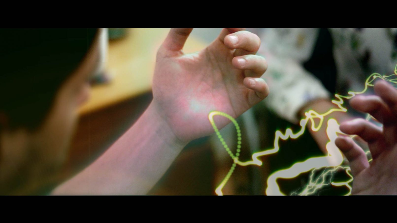 Photo showing VFX of simulated chakra energy in arms and flowing between two people